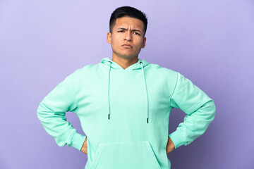 Young Ecuadorian man isolated on purple background angry