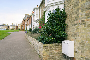 Shallow focus of an external gas mains enclose box seen outside an end of terraced house in the...