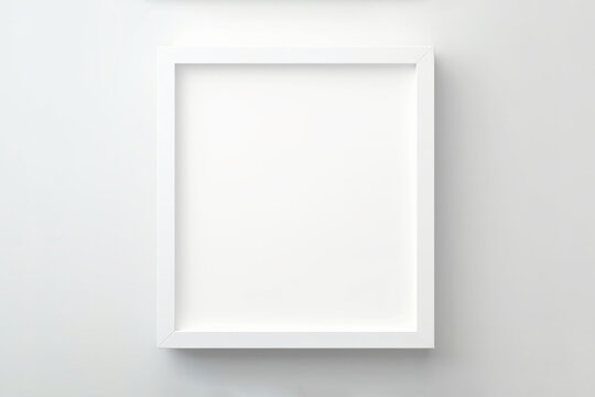 Empty white square photo frame on minimal light wall background with copy space. Mock up template advertisement concept
