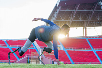 Side view of Disabled asian athlete thailand with prosthetic blades running at stadium. getting ready for the race on the running track at the stadium, physical limitations.