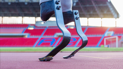 Close up of Disabled asian athlete thailand with prosthetic blades running at stadium. getting ready for the race on the running track at the stadium, physical limitations.