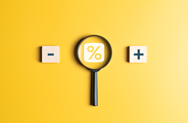 Magnifier with percentage and plus minus symbol. Business growth planning for target to be...