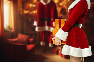 Santa Claus woman with gifts in hands and home interior. 
