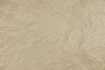  Tactile texture of crumpled beige paper. Wrinkled wrapping paper background. Packaging paper.