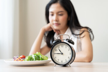 Intermittent Fasting eat concept, Woman looking at meal waiting time to eat during intermittent...