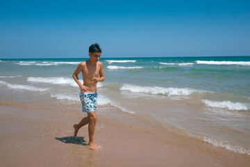 Fototapeta na wymiar Teenager enjoying a fabulous day at the beach.