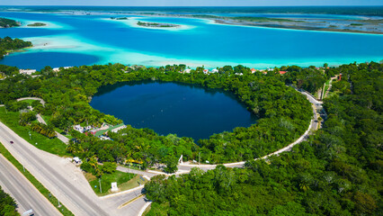 drone revealing cenote in Bacalar Mexico with 7 colours lagoon quintana roo riviera Maya travel destination Mexican resort beach  - obrazy, fototapety, plakaty