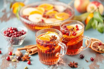 Homemade hot alcohol cranberry orange apple cider punch with cinnamon sticks, anise star and...