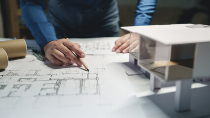 Fototapeta na wymiar Architects interior designer hands working with Blue prints and documents for a home renovation for house design