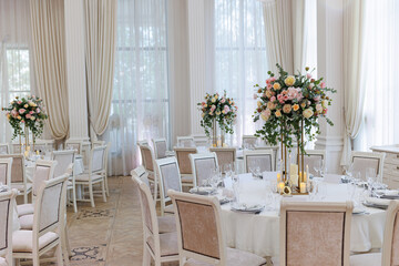 Wedding decorations. Served wedding table with decorative fresh white and pink flowers, candles....