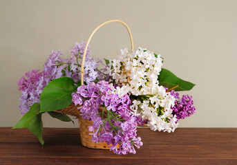 A bouquet of lilacs in a small basket