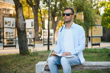 Obraz premium Blind man. Visually impaired man with walking stick,