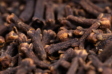 Freshly dryed clove spice texture close up. Cloves spread on the ground. Clove is a dried herb for food flavor and natural medicine. Dry Organic Clove Spice