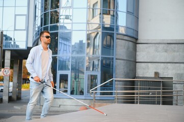 Blind man. Visually impaired man with walking stick,