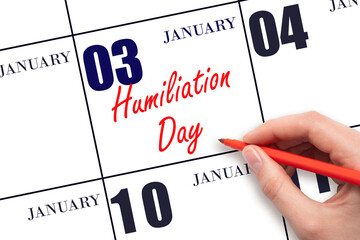 January 3. Hand writing text Humiliation Day on calendar date. Save the date.