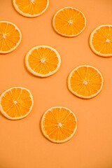 Dried orange circles on a bright light background. View from above
