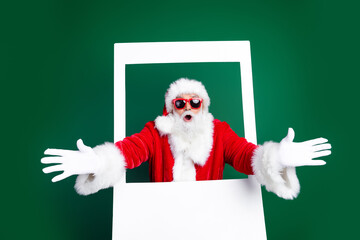 Photo of mature pensioner man stretch hands instant frame dressed stylish santa claus costume coat...