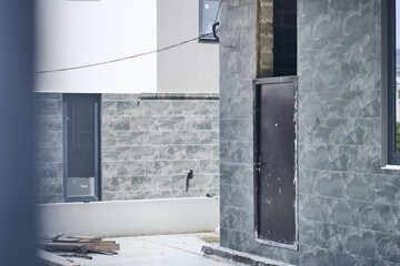 A hotel under construction, iron entrance doors, the exterior of the building. Tourist apartment,...