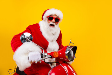 Portrait of funny amazed stunned wondered positive santa claus driving motorbike shocked reaction...
