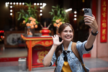 Young beautiful woman asian traveler with smartphone taking selfie travel at market in Thailand