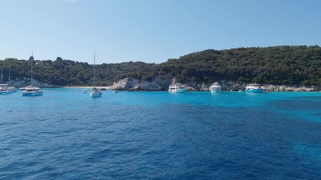 Sailing at iconic tropical paradise beaches of Voutoumi and Vrika with turquoise clear sea, Antipaxos island, Ionian, Greece