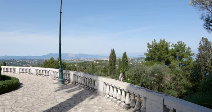 Pov panoramic veiw to Corfu skyline from terrace Traveler in the gardens of Achillion palace on Corfu island, Greece