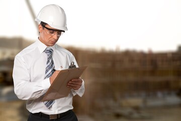 A young attractive supervisor standing at the construction site