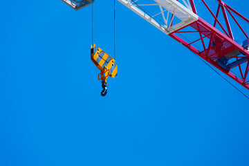 The yellow hook of a crane on a blue sky background. Personal growth concept.	 - 681139200