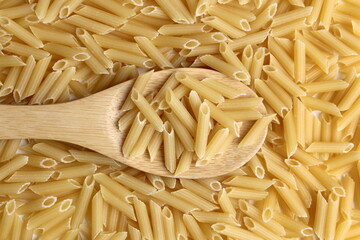  Pasta background with wooden spoon.