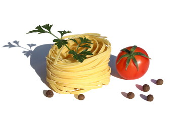  On a white background there is one curled spaghetti in the form of a nest with a tomato and pepper with polka dots decorated with parsley.