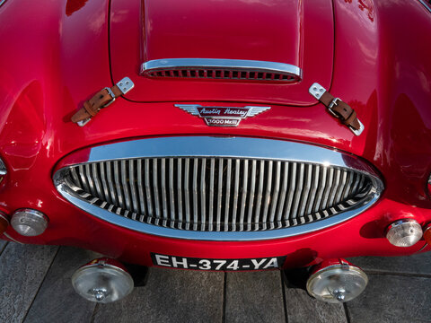 Front top view of red Austin-Healey 3000 BJ8 sports convertible with logotype - a British sports car built from 1959 until 1967. Nice, France - June 8, 2023.