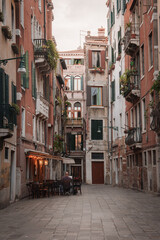 An atmospheric view of an empty street in Venice, Italy. The photo captures the timeless beauty of the city with its charming architecture and tranquil canals.