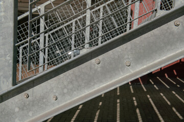 particular structure in galvanized stainless steel, with details of the steel beams and their bolting. anti-intention staircase, pedestrian crossing.