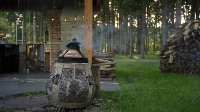 Modern ceramic wood-fired tandoor in outdoor kitchen. 