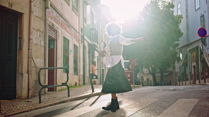 Happy woman spinning road sunny city street. Girl enjoy sunlight on crosswalk.