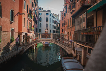 Fototapeta na wymiar A scenic view of a canal in Venice, Italy, showcasing the vibrant atmosphere and typical activities such as water transportation, sightseeing, and dining.