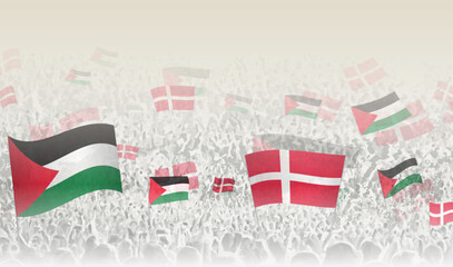 Palestine and Denmark flags in a crowd of cheering people.