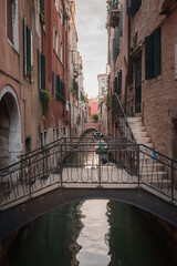 Fototapeta na wymiar A picturesque bridge over a canal in Venice, Italy. The specific location, architectural style, and surrounding details are unspecified, leaving much to the imagination.