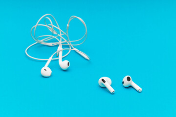 wireless headphones lie next to wired ones.