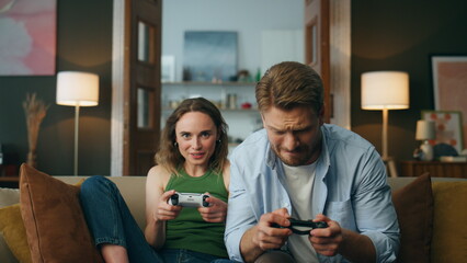 Pov couple playing console game at evening house. Excited active pair video game