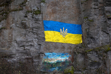 Ukrainian flag is painted on a granite rock	
