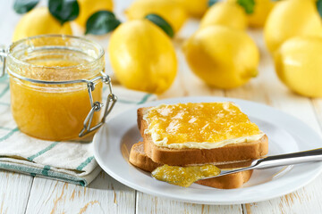 lemon jam sandwiches or toasts on light wooden background. Slices of bread with lemon jam for breakfast .