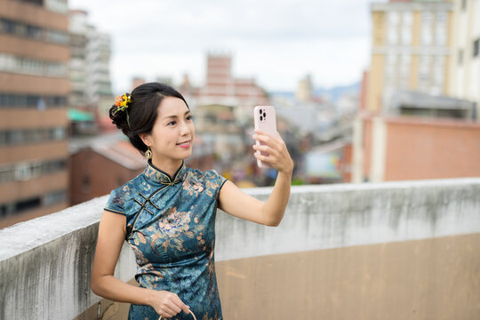 Chinese woman use cellphone to take photo