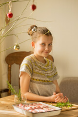 A girl prepares a traditional Christmas dish 