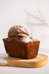 Delicious Christmas cupcake with powdered sugar on a wooden board