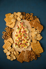 Butter board with sausages and spices in the shape of a Christmas tree