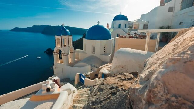 Close-up shot of the scenic blue dome churches in Oia, Santorini, Greece during sunset