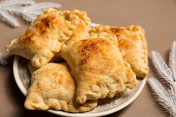 Baked homemade pies with apples from puff pastry decorated