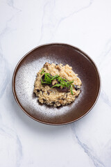 Risotto with mushrooms on a white background.