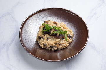Risotto with mushrooms on a white background.